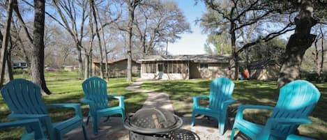 Large backyard with grill, games and a fire pit. 