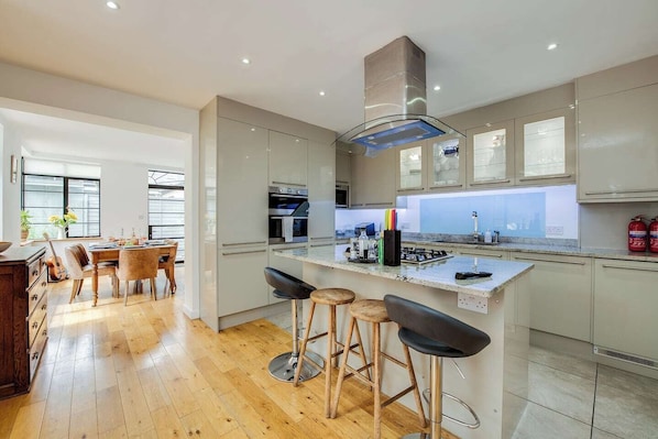Sleek design meets culinary adventure in this bright, stylish space perfect for gatherings!