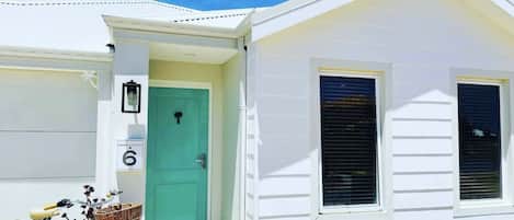 Beach house with iconic turquoise door