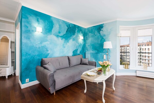 The elegant living room featuring a double sofa bed.