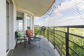 The balcony's stylish design complements the apartment's decor. 