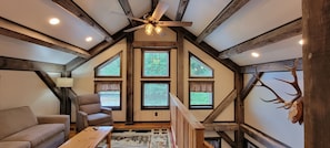 Cozy 2nd Floor Lounging Area with elegant wood structure.