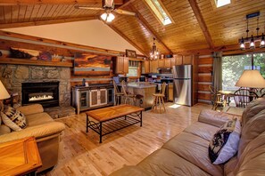 Bright and spacious living room with open kitchen and lots of natural sunlight.