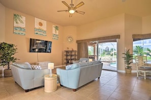 Living room with high ceilings, 75" Smart TV w/ cable.  Sliding door to lanai!