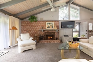 Enjoy the wood-burning fireplace while you watch the giant flat-screen TV.