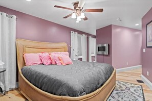 Master bedroom with king sized bed and full en suite bathroom.
