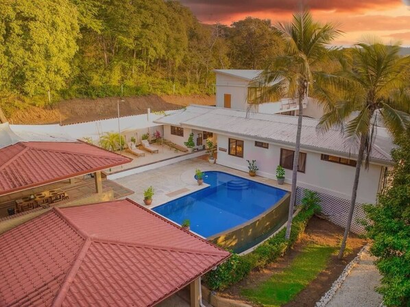 Welcome to your tropical oasis! Imagine waking up to the sunrise over the lush greenery, taking a dip in the infinity pool, and enjoying the peaceful surroundings. This serene escape offers the perfect blend of luxury and nature, with spacious outdoor areas and cozy indoor spaces. Relax, unwind, and make unforgettable memories in this stunning retreat.