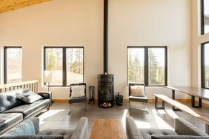 Warmth Meets Style: Great Room with Striking Fireplace and Kitchen Vista