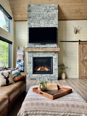 Beautiful gas fireplace with 65 inch Smart TV.