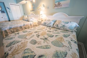 - Drift into relaxation with these plush queen size beds and serene coastal decor - Soft seashell-patterned bedding and warm lighting create the perfect beach retreat - Wake up refreshed and ready for another sun-soaked day by the ocean