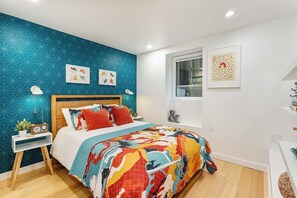 Drift off in a fun, art-filled bedroom featuring a cozy double bed with a Casper mattress, soft cotton sheets, and a soothing sound machine!