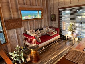 Comfortable Second Floor with epic views, cozy seating area with Twin Day Bed, dining area, kitchen, and wrap around lanai.
