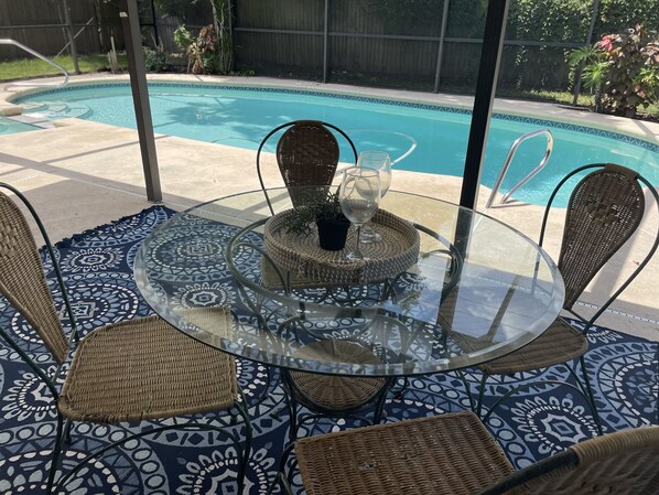 Beautiful, covered, screened lanai overlooking pool and backyard. 