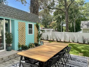 Private outdoor dining area. There is also a lounging space on a deck.