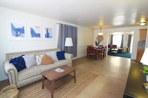 View of front sitting room, dining table for 6, and living room