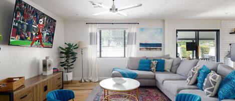 Bright and spacious living room with flat screen TV.