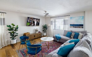 Bright and spacious living room with flat screen TV.