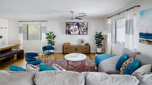 Bright and spacious living room with flat screen TV.