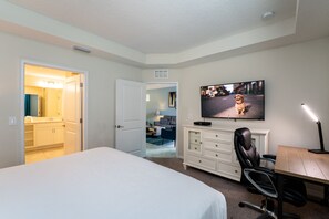 master  bedroom showing TV and master bathroom