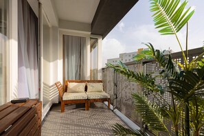 The balcony provides a perfect spot for enjoying the fresh air. 