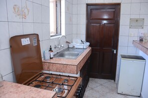 Kitchen with gas oven and mini fridge