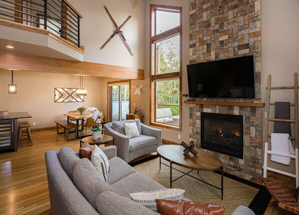 Floor-to-ceiling windows soak the open-concept great room in light.