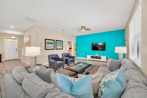 Bright and inviting living room with plenty of seating and entertainment!