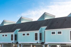 Atlantic Escape is part of quadplex. It is the end unit townhome on the far right of this photo.