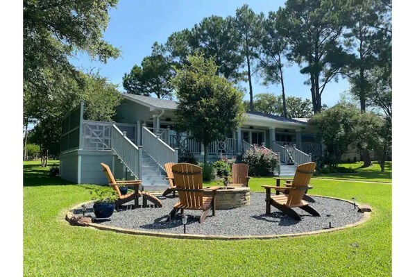 Firepit on back of house with stairs leading up to spa
