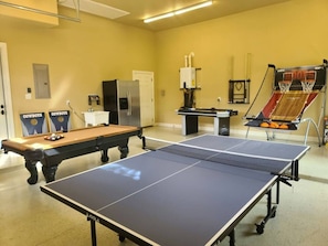 Game room with pool air hockey, basketball and cornhole