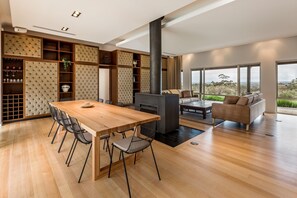 Gather around the stunning timber dining table, designed for memorable meals shared with family and friends.