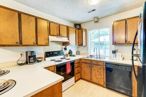 Kitchen is stocked with pots and pans. Everything you'll need to whip up your next meal!