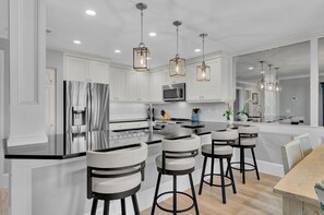 Barstool seating at the fully equipped kitchen.