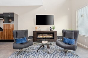 70' inch smart TV in living area with Netflix, HULU, Amazon Prime app included