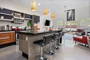 Cook and gather in a fully equipped kitchen, featuring sleek appliances, ample counter space, and a stylish design that makes every meal a delight.
