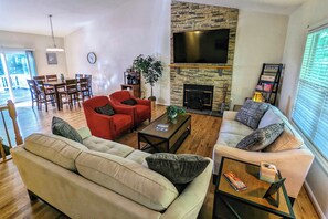 Living Room: A spacious gathering/seating area with a 75" TV