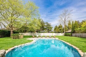 Heated pool with lounge chairs and umbrellas 