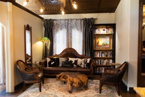 This living room faces a 75-inch television    and shouts, "Welcome to Texas!"