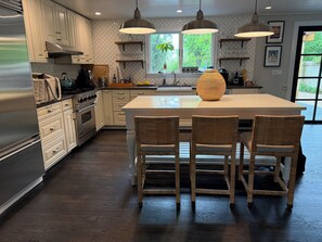 Large chefs kitchen with island and seating for 3 or more 