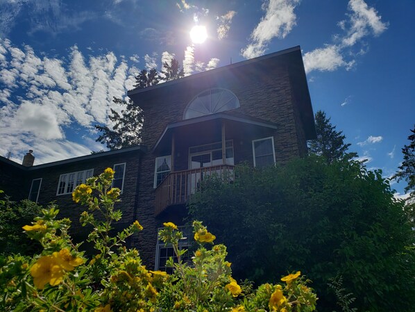 An evening summer view of the balcony from the courtyard below