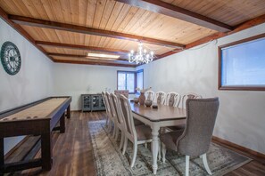 Dining room has large table to comfortably seat 10 and a shuffleboard for a break from digital devices.