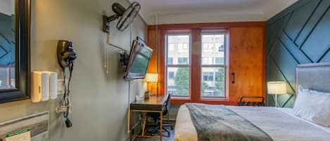 Remodeled room with queen bed, 50" TV, mini fridge, desk, and all the basics.