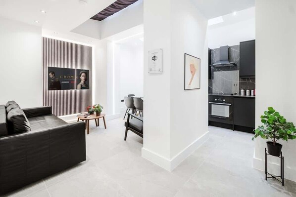 Relax in style: elegant living room, 65-inch Smart TV, premium air-conditioning.