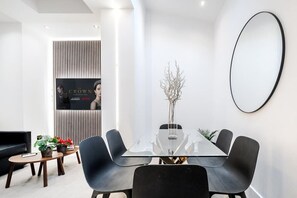 Relax in style: elegant living room, 65-inch Smart TV, premium air-conditioning.