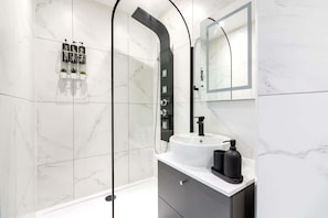 Enjoy 2 full bathrooms with towels, soaps, and toilets featuring built-in bidets