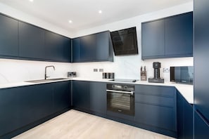 Fully-equipped kitchen with washer, dryer, dishwasher, espresso, water dispenser