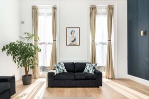 Relax in our elegant, spacious living room with air-con and 90-inch Smart LED TV