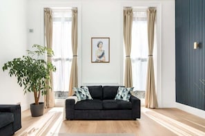 Relax in our elegant, spacious living room with air-con and 90-inch Smart LED TV