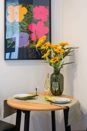 A close-up of a floral wall art piece, adding a vibrant and decorative touch to the room.
