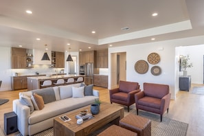Spacious living room - The living room is designed as an open floor plan and is a great gathering place for meals, games, or watching TV during your stay.